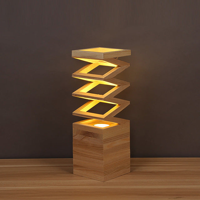 woodnestcraft The Fold Lamp featuring a sculptural accordion-style solid wood design with warm glowing light