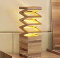 woodnestcraft Fold Lamp featuring a sculptural accordion design made from solid wood with a warm glowing light