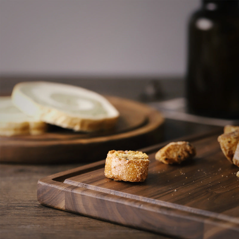 woodnestcraft solid North American black walnut rectangular cutting board with juice groove and bread pieces