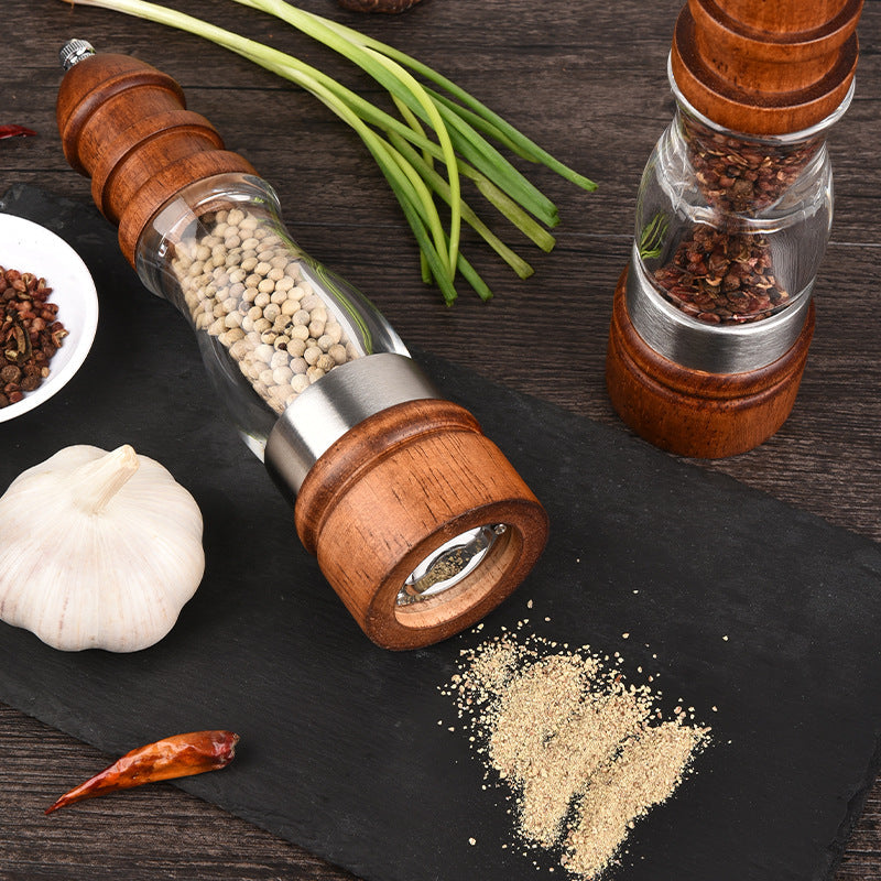 woodnestcraft salt and pepper grinder set with rubberwood base and clear acrylic body on a dark slate board