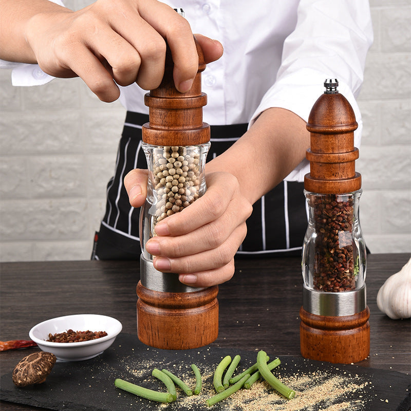 woodnestcraft wooden salt and pepper grinder with clear acrylic body and ceramic mechanism being used by a chef